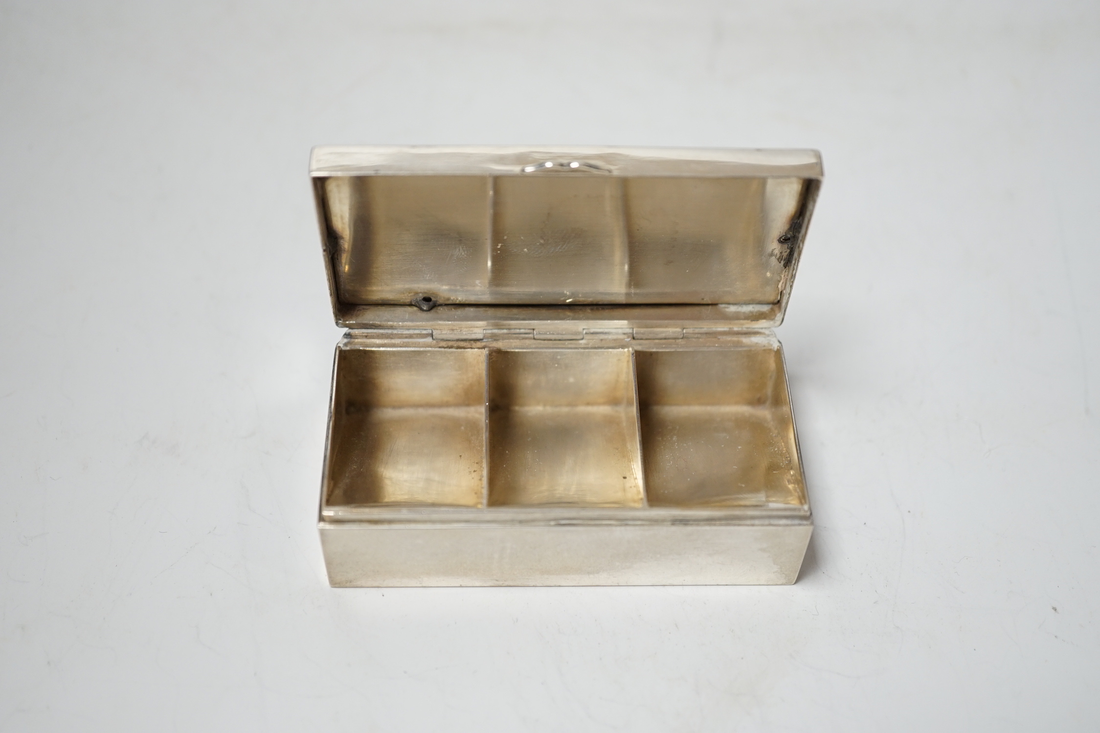 A continental white metal triple compartment rectangular stamp box(ex surmount?), 72mm.